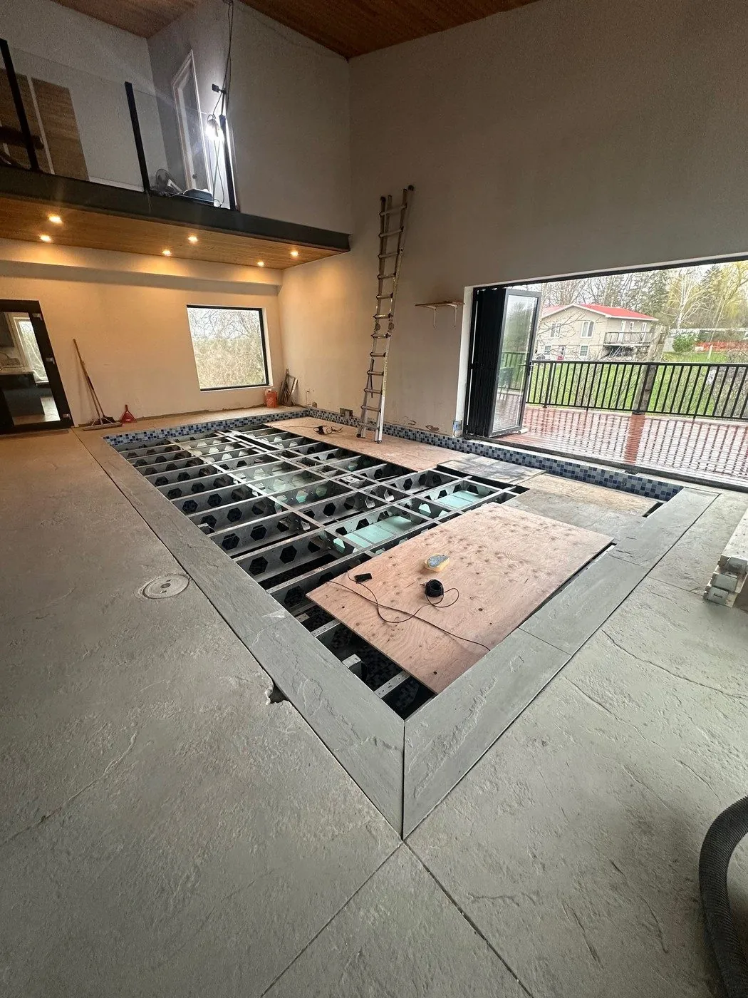 Complete stainless steel WaveLift structure during installation in a Cambridge indoor pool